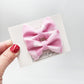 Pink checker pigtail bows