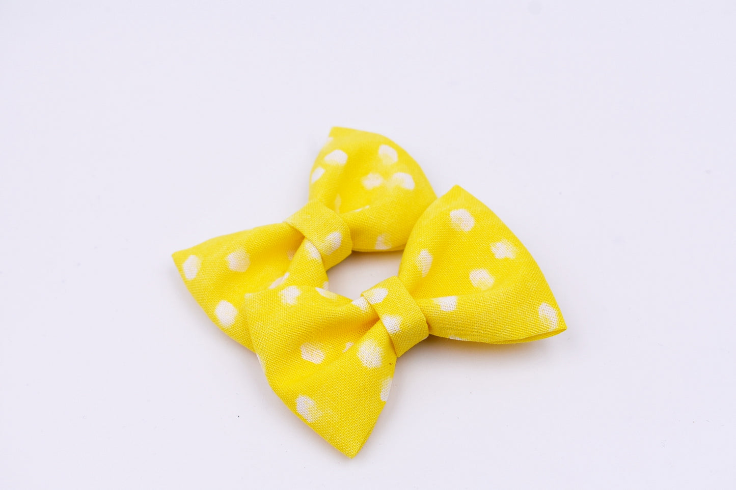 Yellow and white polka dot pigtail hair bows