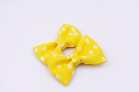 Yellow and white polka dot pigtail hair bows