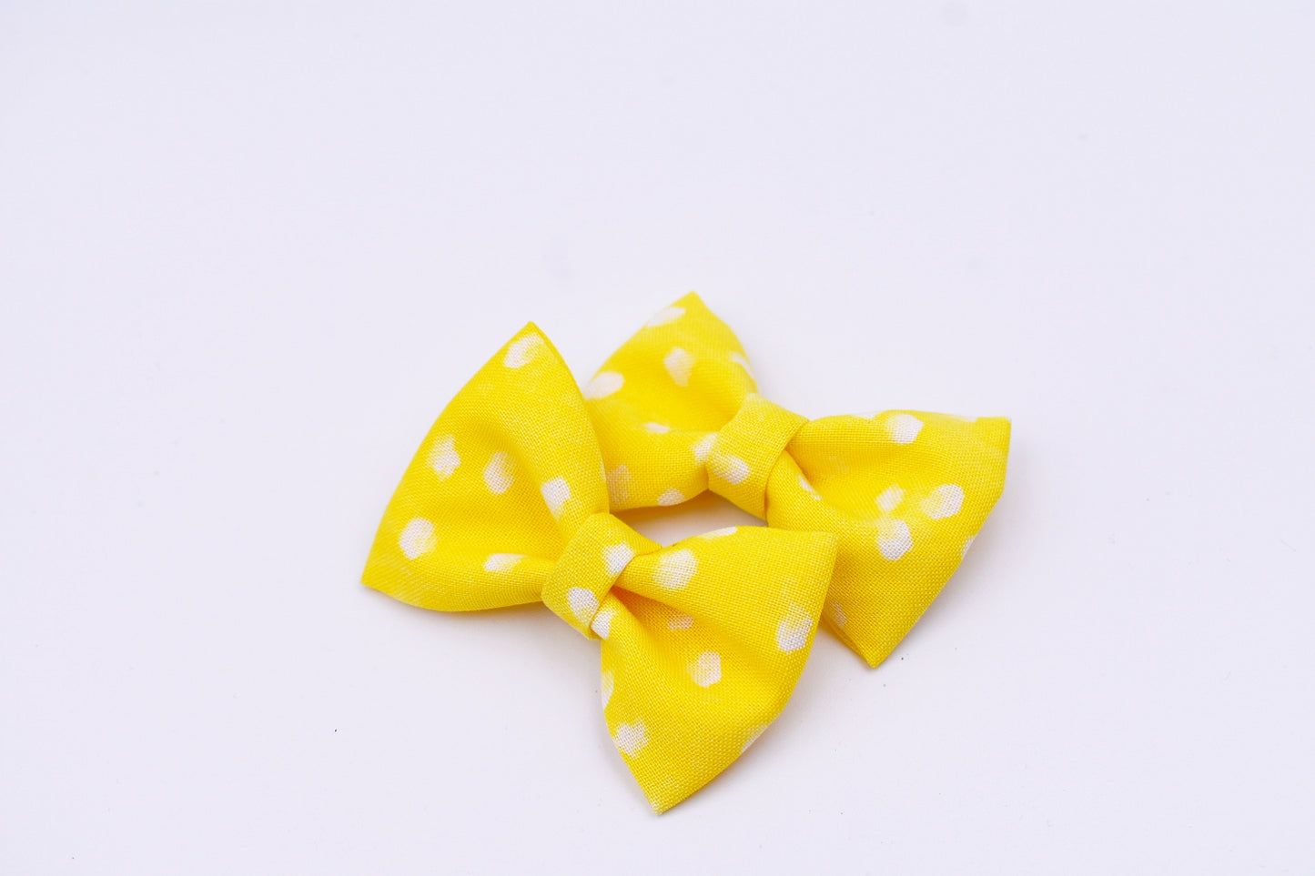 Yellow and white polka dot pigtail hair bows