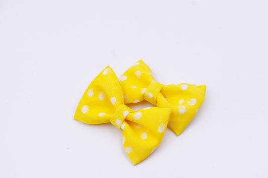 Yellow and white polka dot pigtail hair bows